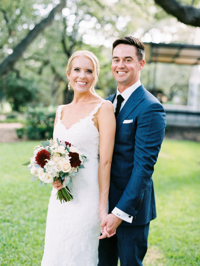 Film Fall wedding in Austin, Texas. Bride and Groom portraits before ceremony. Groom is wearing a navy suit, bride is wearing a lace wedding dress.